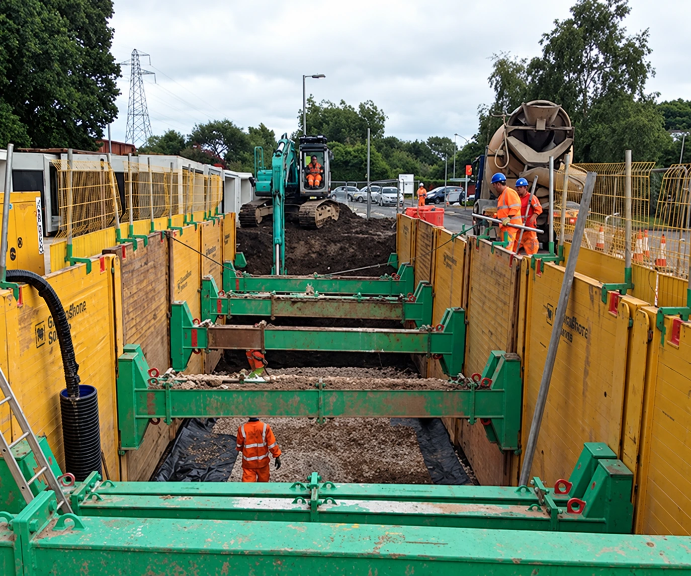 Workers and temporary trench support on a construction site, from Derryard’s existing website